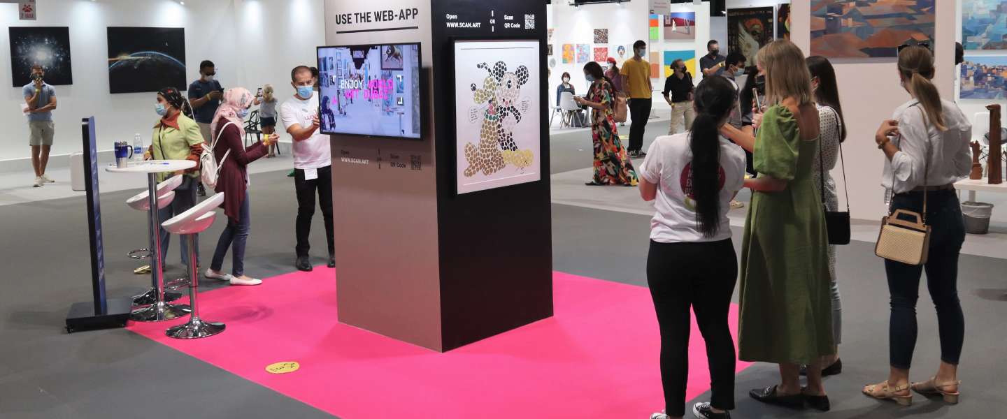 visitors scanning an artwork